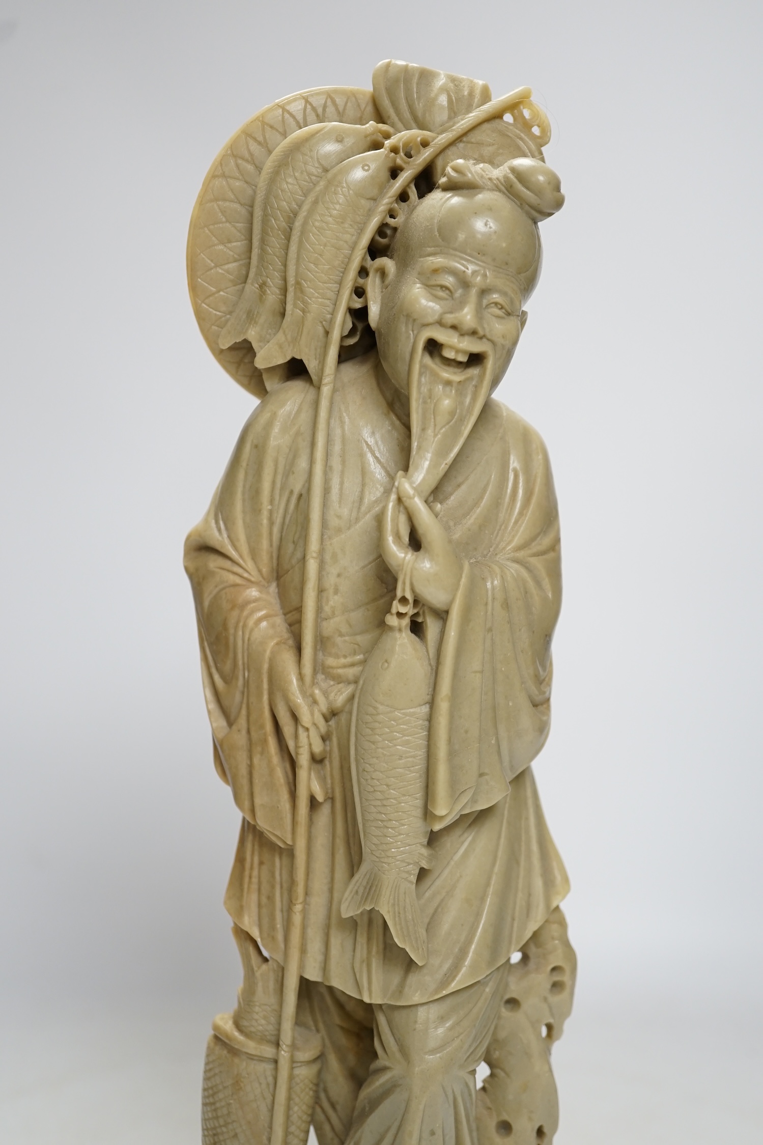 A tall Chinese soapstone figure of a fisherman, 40cm high. Condition - good